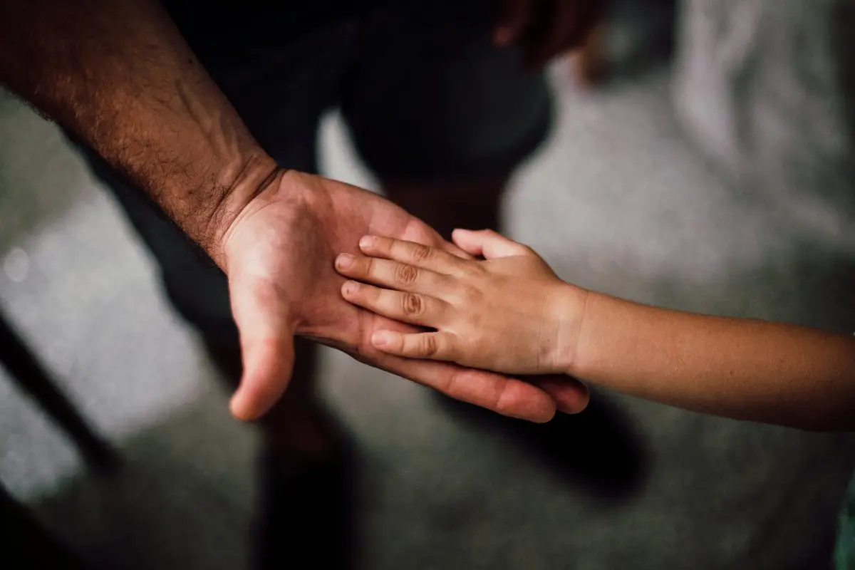 selective focus photography of child hand