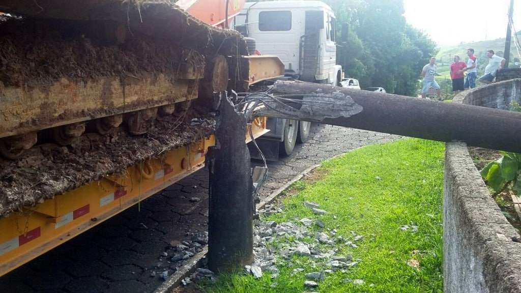 Carreta transportando escavadeira bate e derruba poste na rua dos Imigrantes